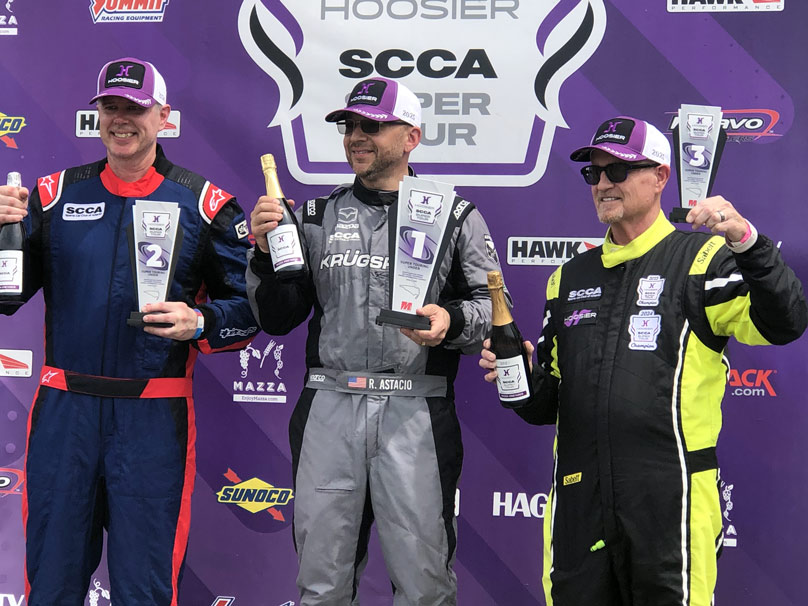 Rich winning a trophy after a race